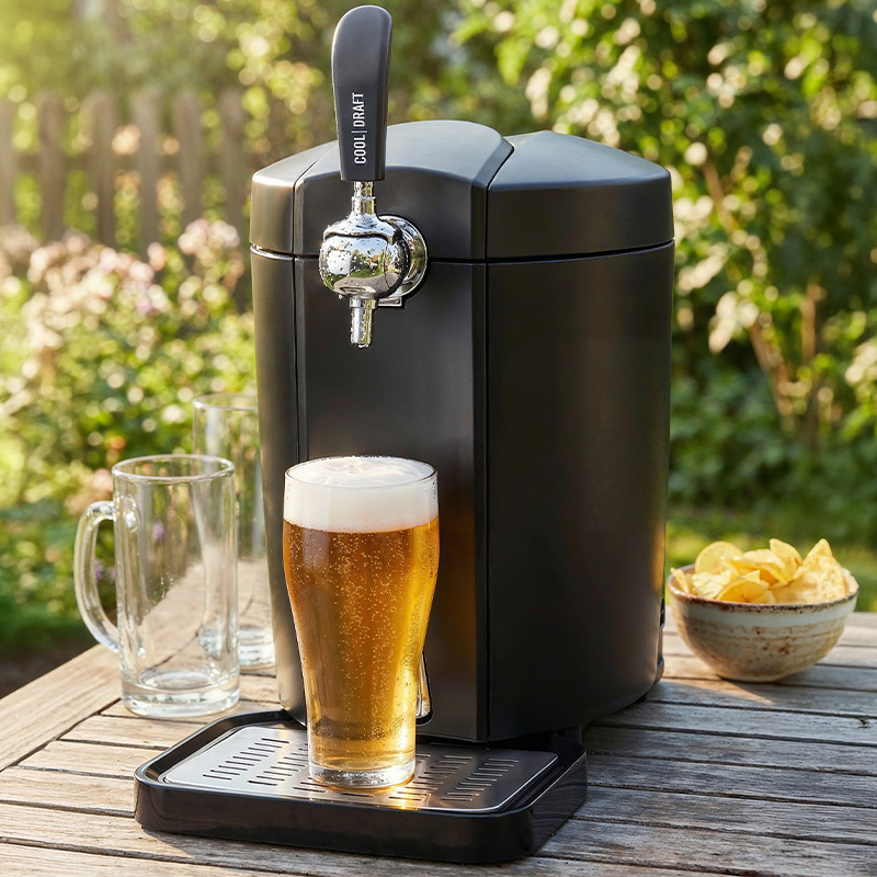Beer dispenser Trisa Cool Draft with freshly poured beer on a garden table.